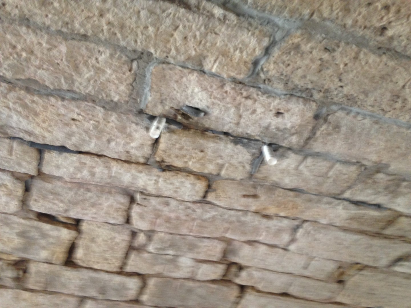 Close-up of masonry bridge joints being maintained